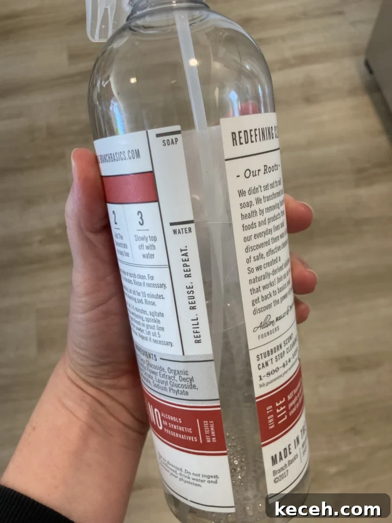 a person holding a Concentrate bottle of Branch Basics Starter Kits
