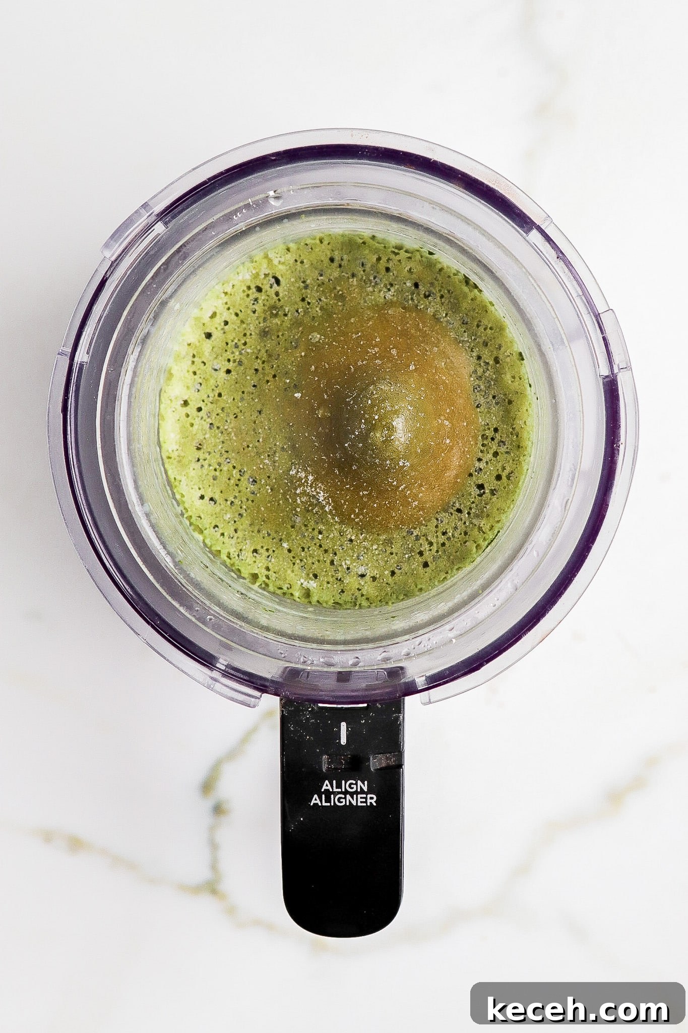Top down view of frozen green dessert in ninja creami pint container.