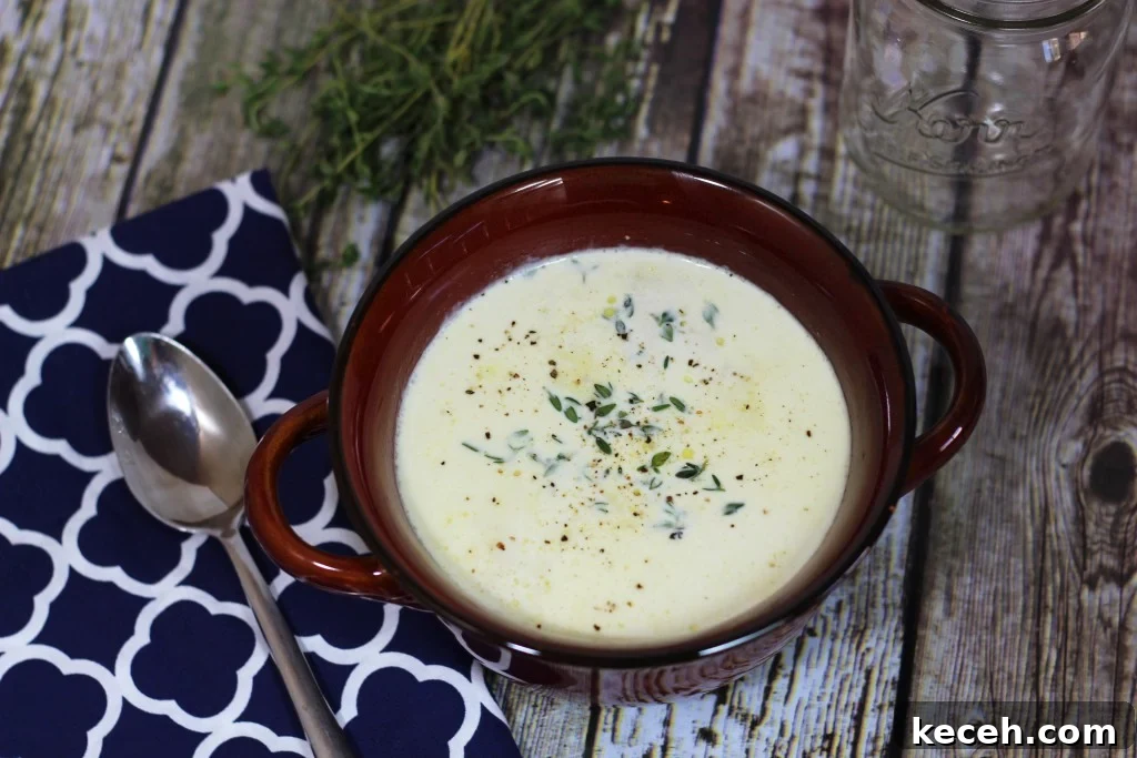 Creamy Truffled Cauliflower Soup Recipe for Gourmet Flavor 4 A bowl of truffled cauliflower soup on a wooden table.