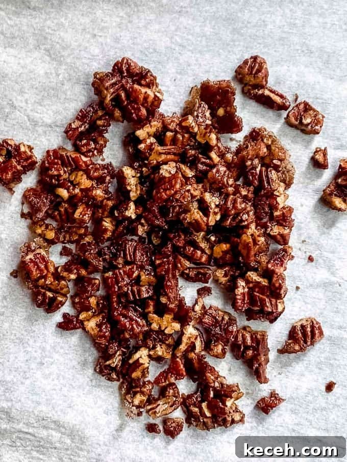 Vegan Pumpkin Cheesecake with Candied Pecans — Holiday Dessert Recipe 11 An overhead view of a pile of coated pecans