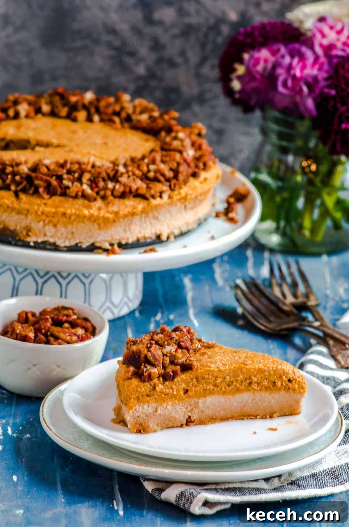 Vegan Pumpkin Cheesecake with Candied Pecans — Holiday Dessert Recipe 13 A slice of vegan cheesecake with pumpkin mousse on a plate