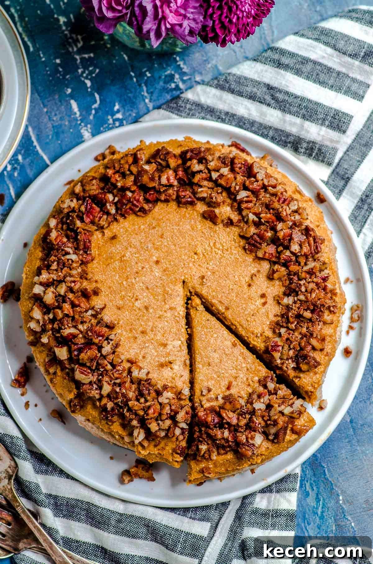 Vegan Pumpkin Cheesecake with Candied Pecans — Holiday Dessert Recipe 3 An overhead view of vegan cheesecake with a slice cut out