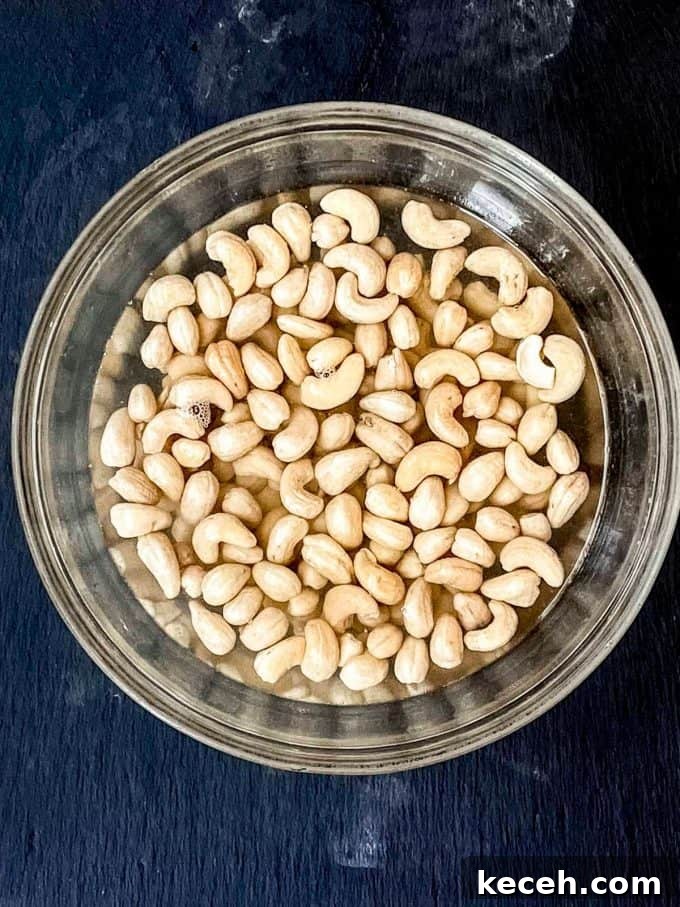 Vegan Pumpkin Cheesecake with Candied Pecans — Holiday Dessert Recipe 6 an overhead view of cashews being soaked in boiling water