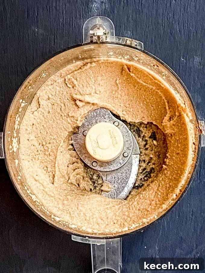 Vegan Pumpkin Cheesecake with Candied Pecans — Holiday Dessert Recipe 8 an overhead view of pumpkin mousse in a food processor
