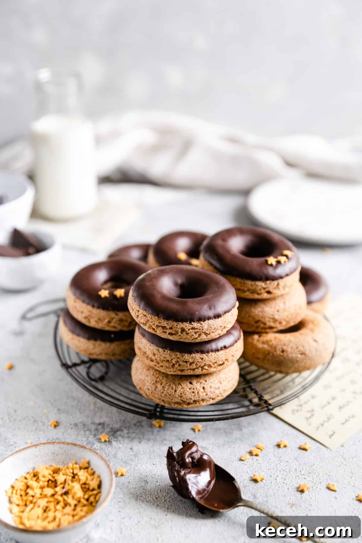 Baked Donuts with Rich Chocolate Glaze Recipe 2 Straight ahead shot of baked doughnuts with chocolate glaze on a round cooling rack