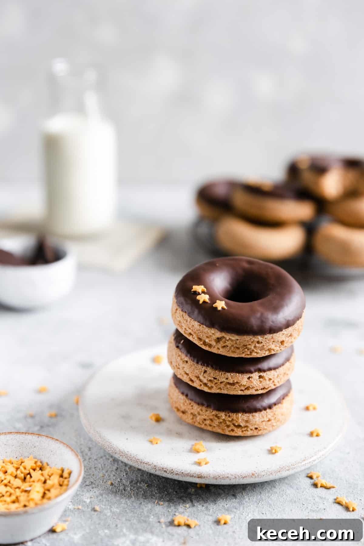 Baked Donuts with Rich Chocolate Glaze Recipe 13 straight ahead shot of 3 baked doughnuts on a small plate stacked together