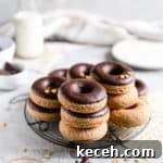 Baked Donuts with Rich Chocolate Glaze Recipe 15 small stacks of baked doughnuts on a round cooling rack