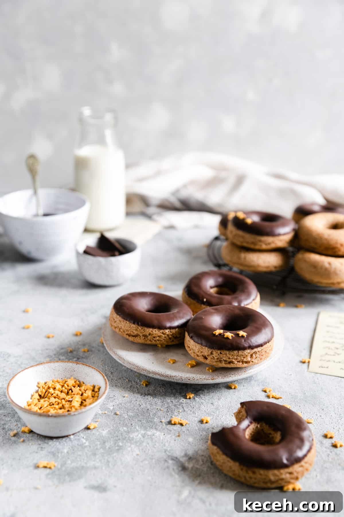 Baked Donuts with Rich Chocolate Glaze Recipe 4 small plate with 3 baked doughnuts with chocolate glaze