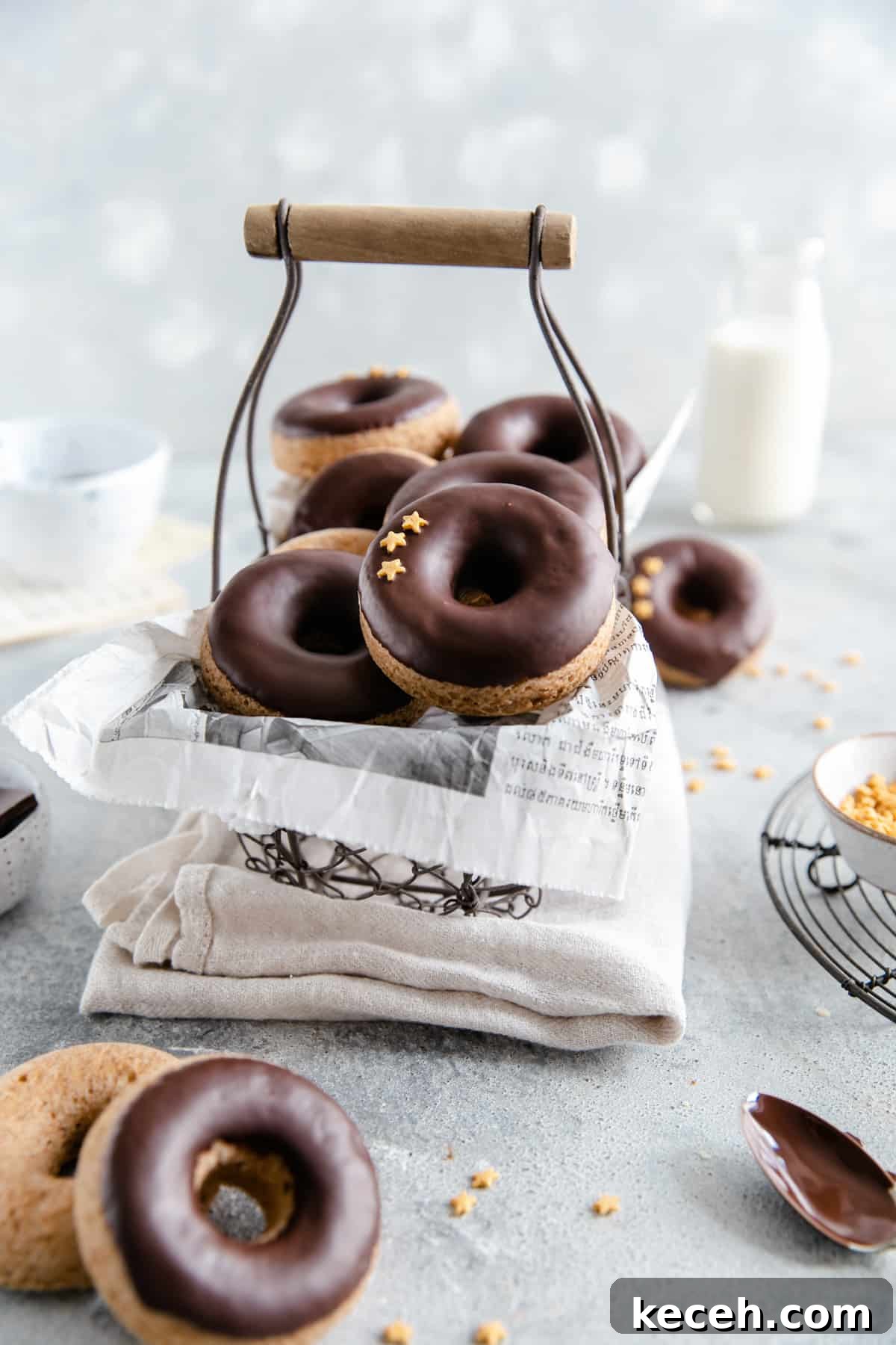 Baked Donuts with Rich Chocolate Glaze Recipe 7 straight ahead shot of small wired basket filled with baked doughnuts with chocolate glaze