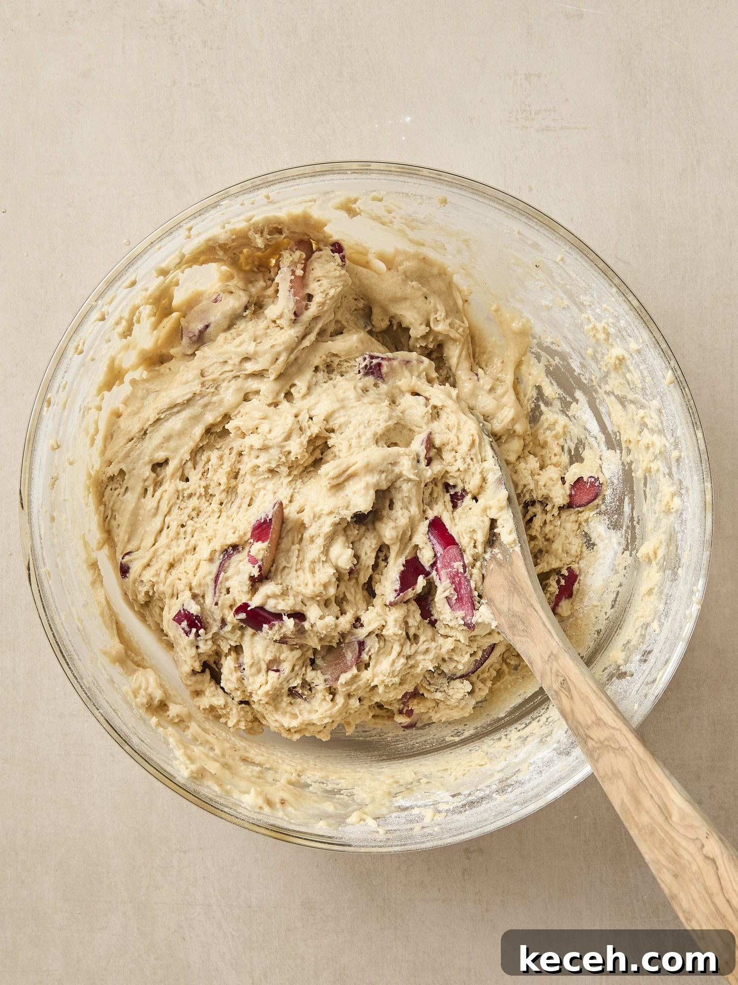 Tangy Rhubarb Muffins with Crunchy Streusel Topping 5 Bowl with batter with pieces of rhubarb stirred in.