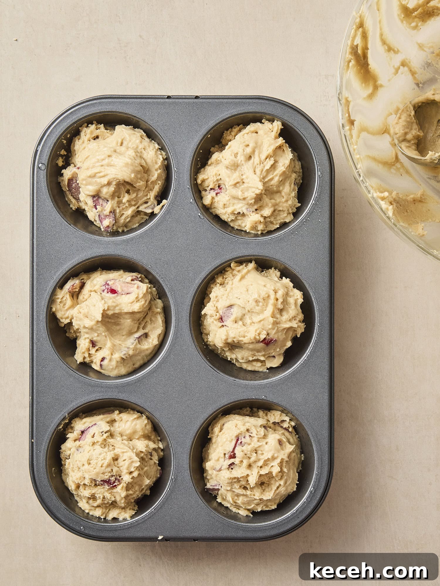 Tangy Rhubarb Muffins with Crunchy Streusel Topping 7 Muffin pan with batter in the tins.