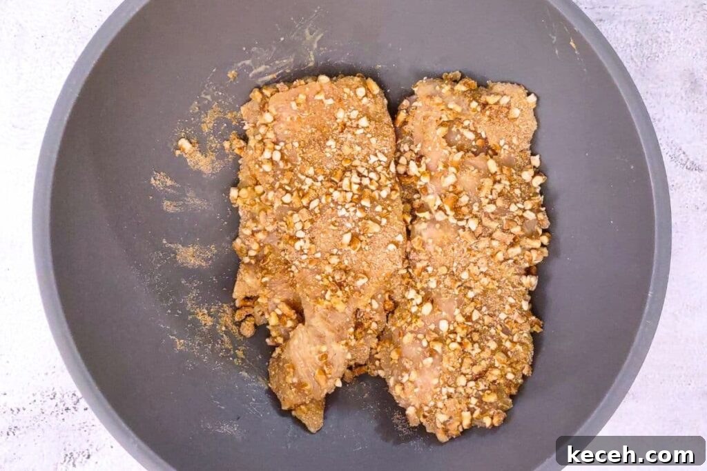 mix coated chicken in broken pretzel pieces