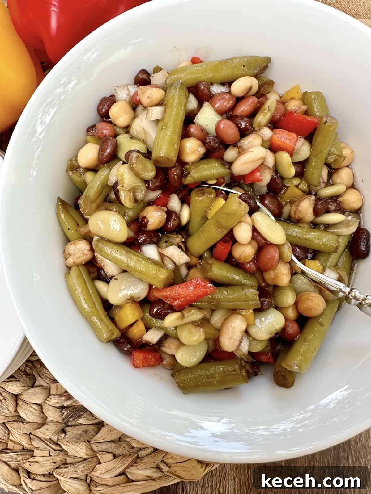 Zesty Mixed Bean Salad with Lemon Herb Dressing 4 A spoon dishing up serving of bean salad.
