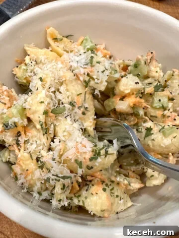 Pasta salad with Italian dressing in a bowl with a fork.