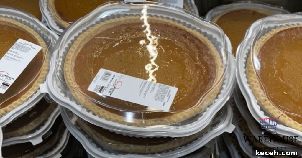 Costco pumpkin pie in its signature clamshell container on a Thanksgiving table.