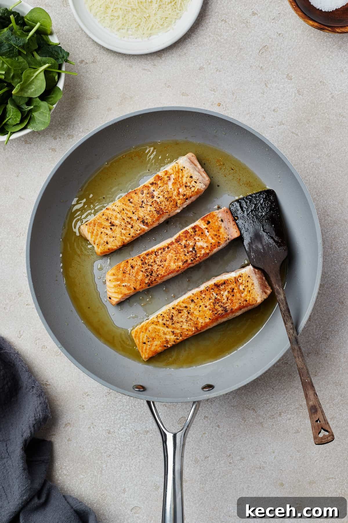 Creamy Spinach Salmon Florentine Recipe for Weeknight Dinners 5 Salmon fillets cooking in a skillet.