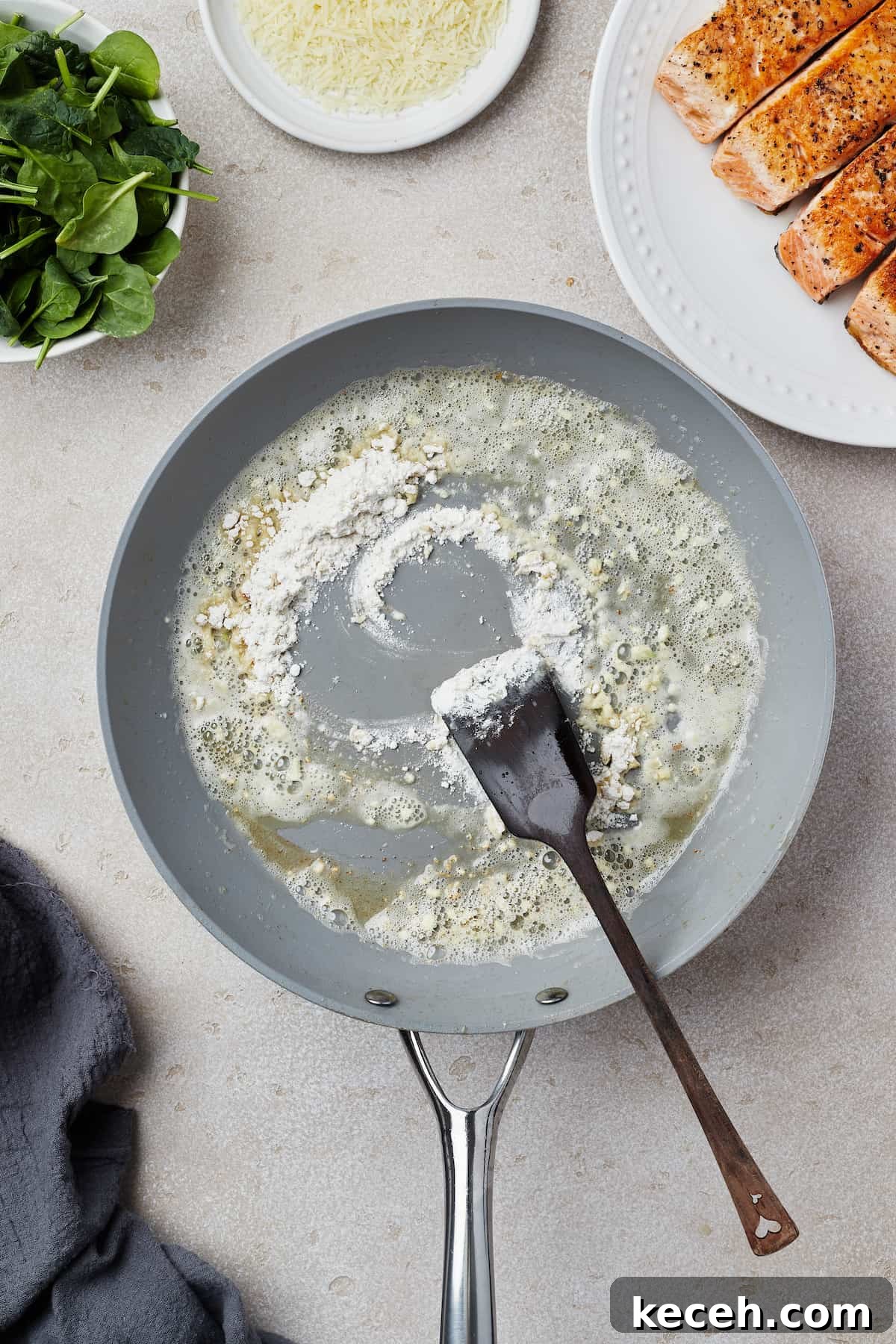 Creamy Spinach Salmon Florentine Recipe for Weeknight Dinners 6 A skillet with melted butter, garlic, and flour cooking in it.
