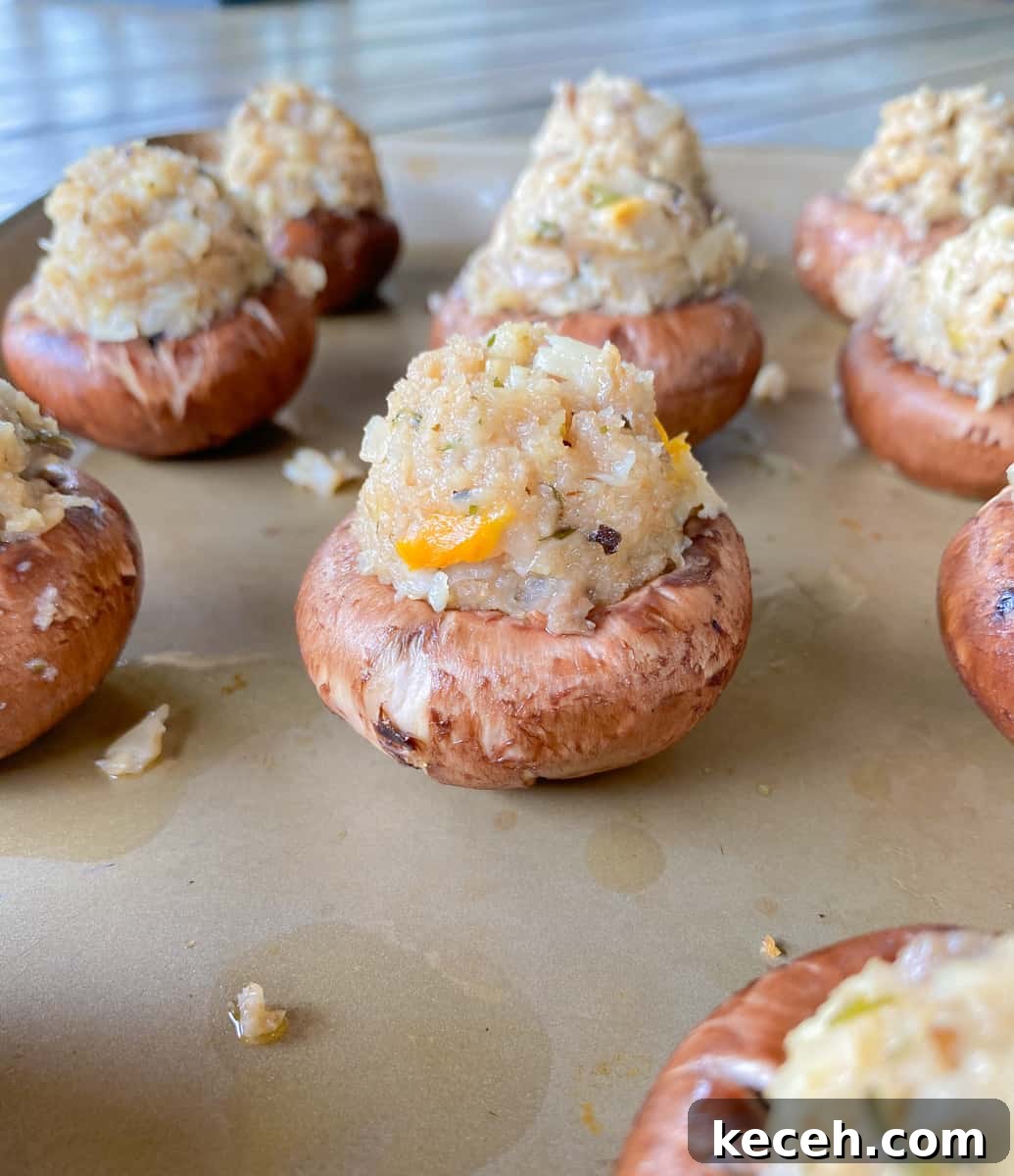 Olive Garden Clam-Stuffed Mushrooms Recipe: Copycat Appetizer 4 raw mushrooms on a baking sheet stuffed with a Italian clam breadcrumb filling.