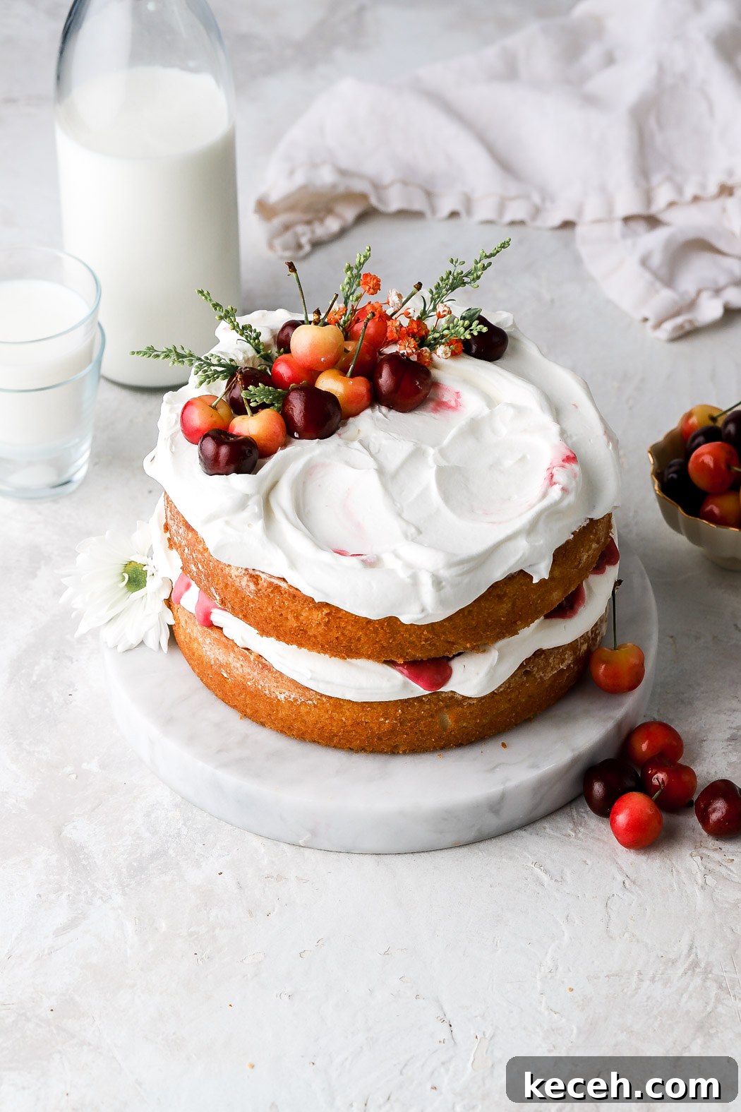 white forest cake with whipped cream and cherries