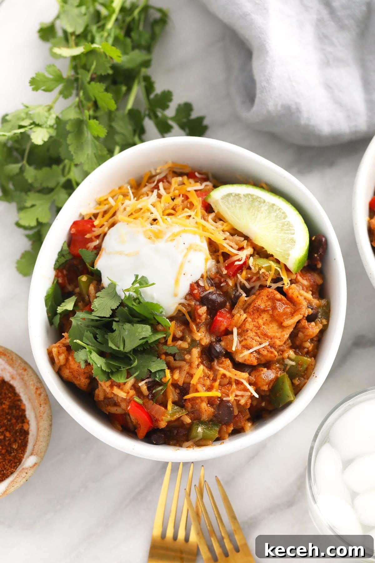 Instant Pot Burrito Bowls instant pot burrito bowl topped with shredded cheese and greek yogurt and cilantro
