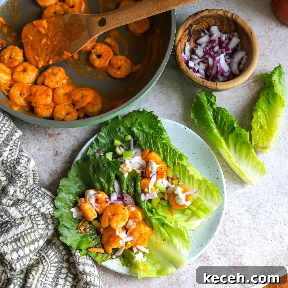 Spicy Buffalo Shrimp Lettuce Cups Recipe for Game Day 6 finished meal on a plate with lettuce.