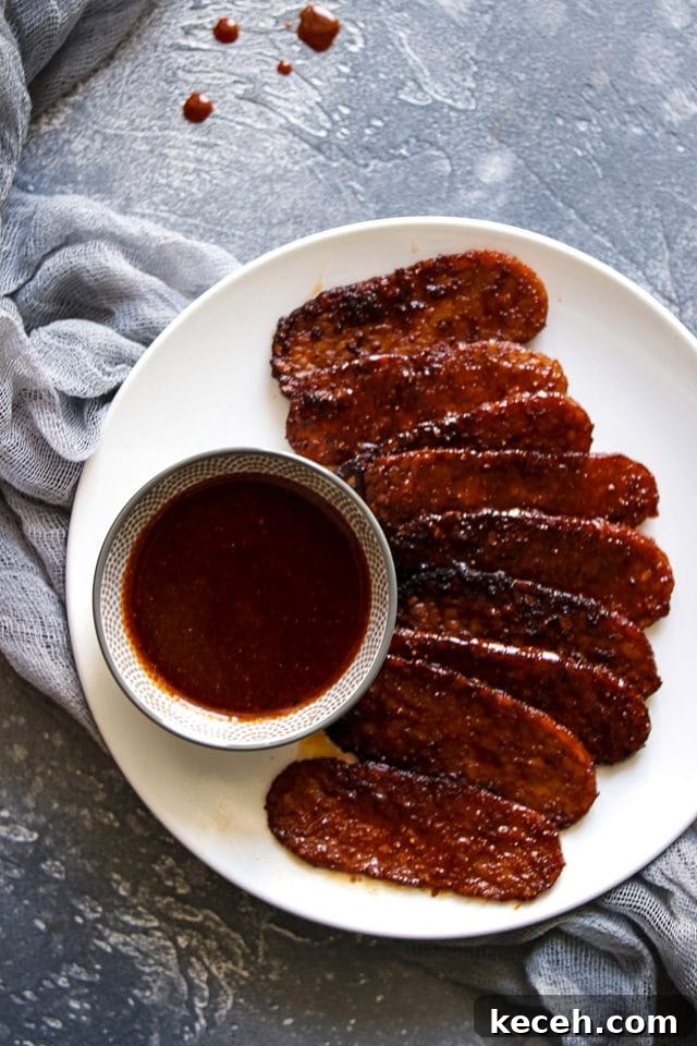 How to Cook Tempeh: Simple Techniques for Flavorful Results 6 Smoky Tempeh on a Plate with a Little Bowl of Marinade