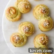 Tangzhong Method: Make Soft, Tender Breads and Buns Every Time 11 St. Lucia Buns on a marble plate.