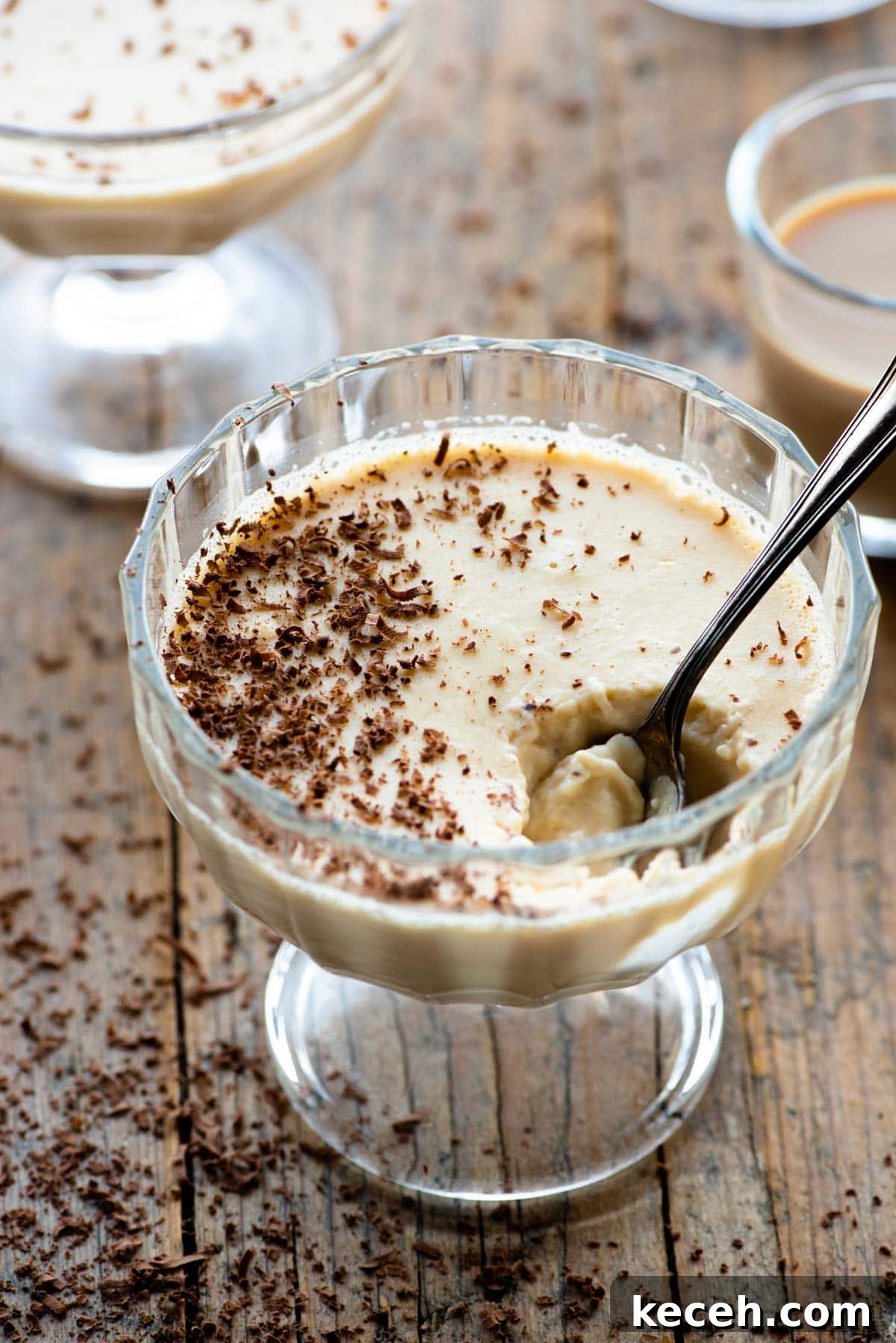 Bailey’s Liqueur Panna Cotta Recipe: Silky Boozy Dessert 2 Baileys panna cotta in a small glass dish with a spoon and grated chocolate on top