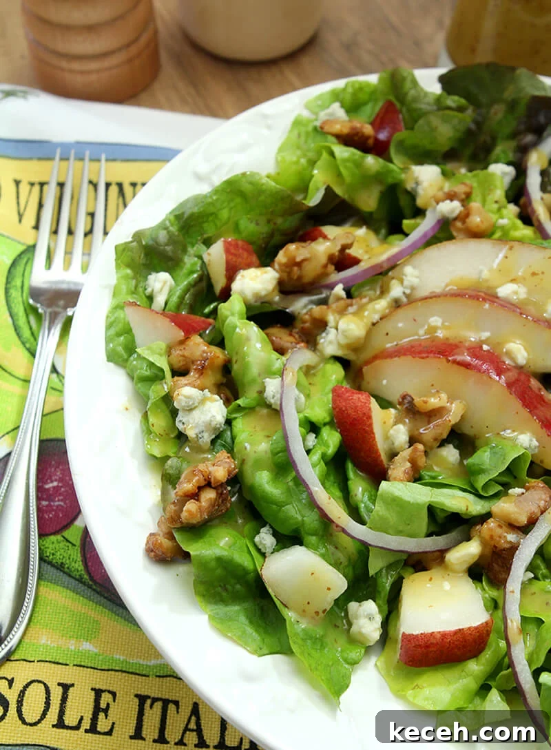 Pear, Walnut & Gorgonzola Salad with Maple-Dijon Vinaigrette 4 White Plate with Salad with Greens, Pear, Walnuts, and Gorgonzola Cheese
