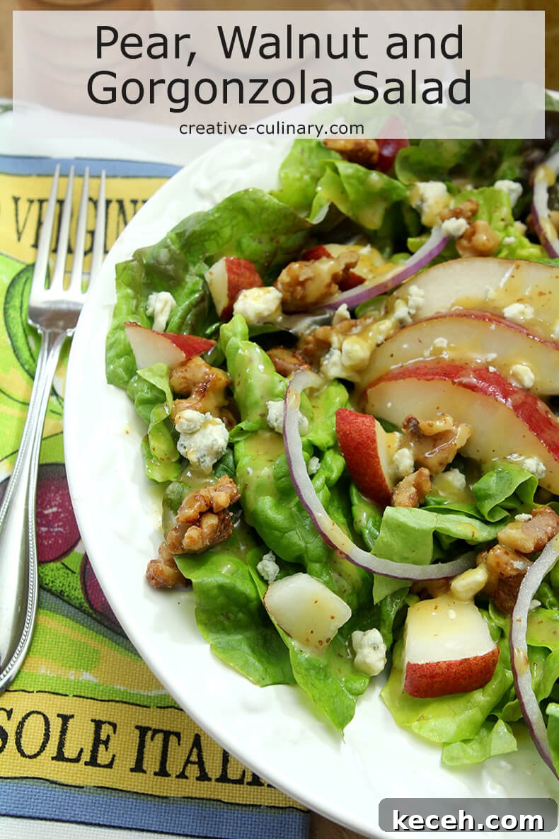 Pear, Walnut & Gorgonzola Salad with Maple-Dijon Vinaigrette 6 Salad with Greens, Pear, Walnuts, and Gorgonzola Cheese on White Plate