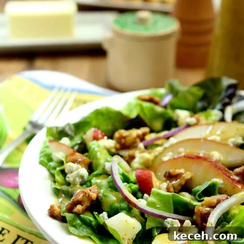 Pear, Walnut & Gorgonzola Salad with Maple-Dijon Vinaigrette 7 Salad with Greens, Pear, Walnuts, and Gorgonzola Cheese in White Salad Bowl