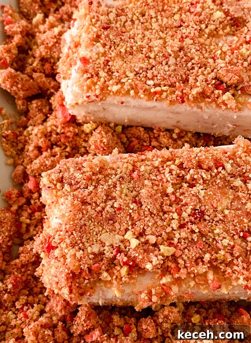 a close up of homemade strawberry crunch ice cream bars