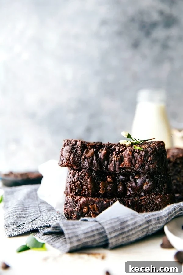 This rich Chocolate Zucchini Bread is moist, deeply chocolatey, and completely irresistible! Chocolate Zucchini Bread slices stacked on top each other