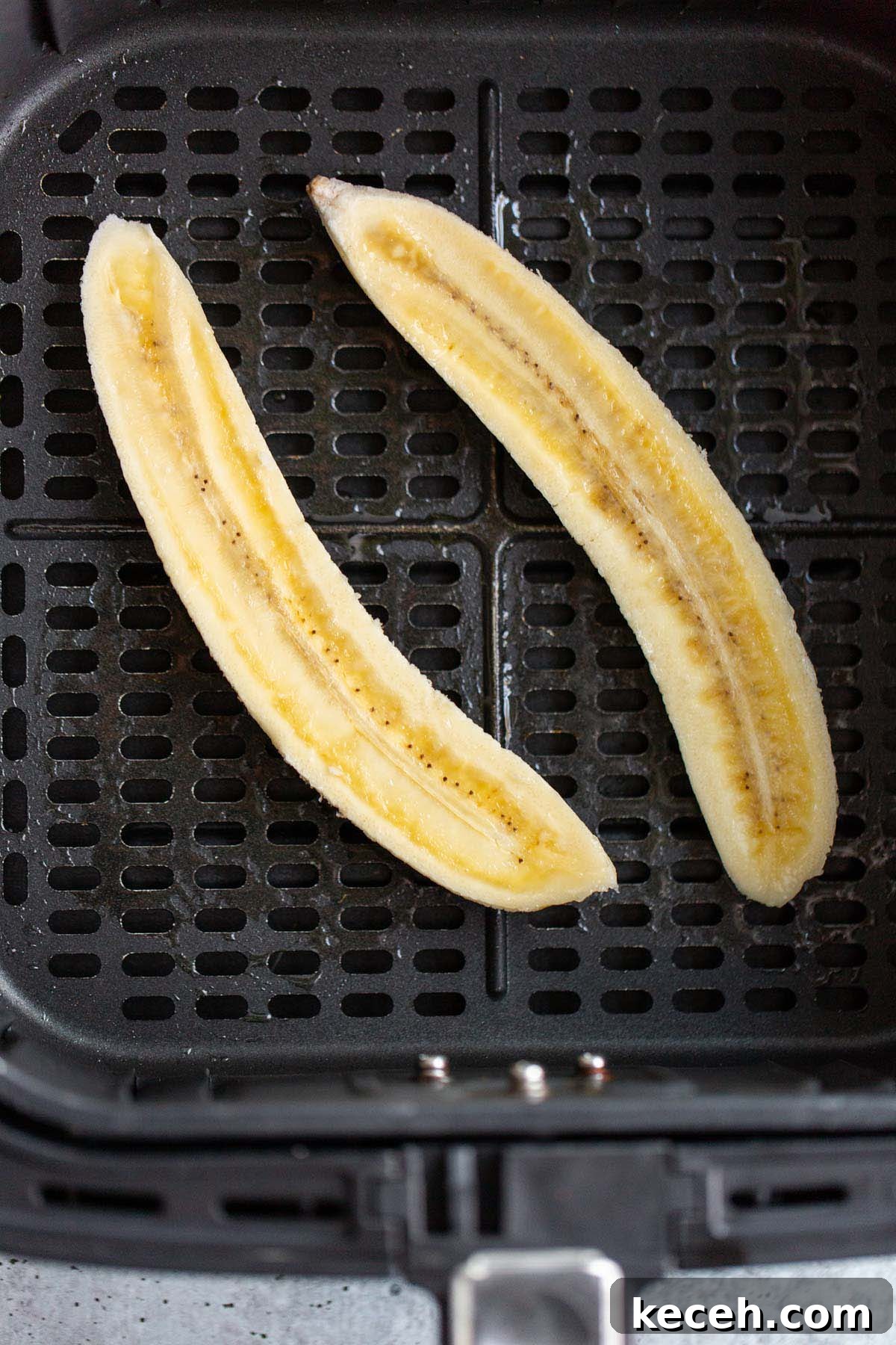 Air Fryer Banana Split Dessert with Warm Caramel and Crisp Toppings 4 Sliced banana in air fryer.