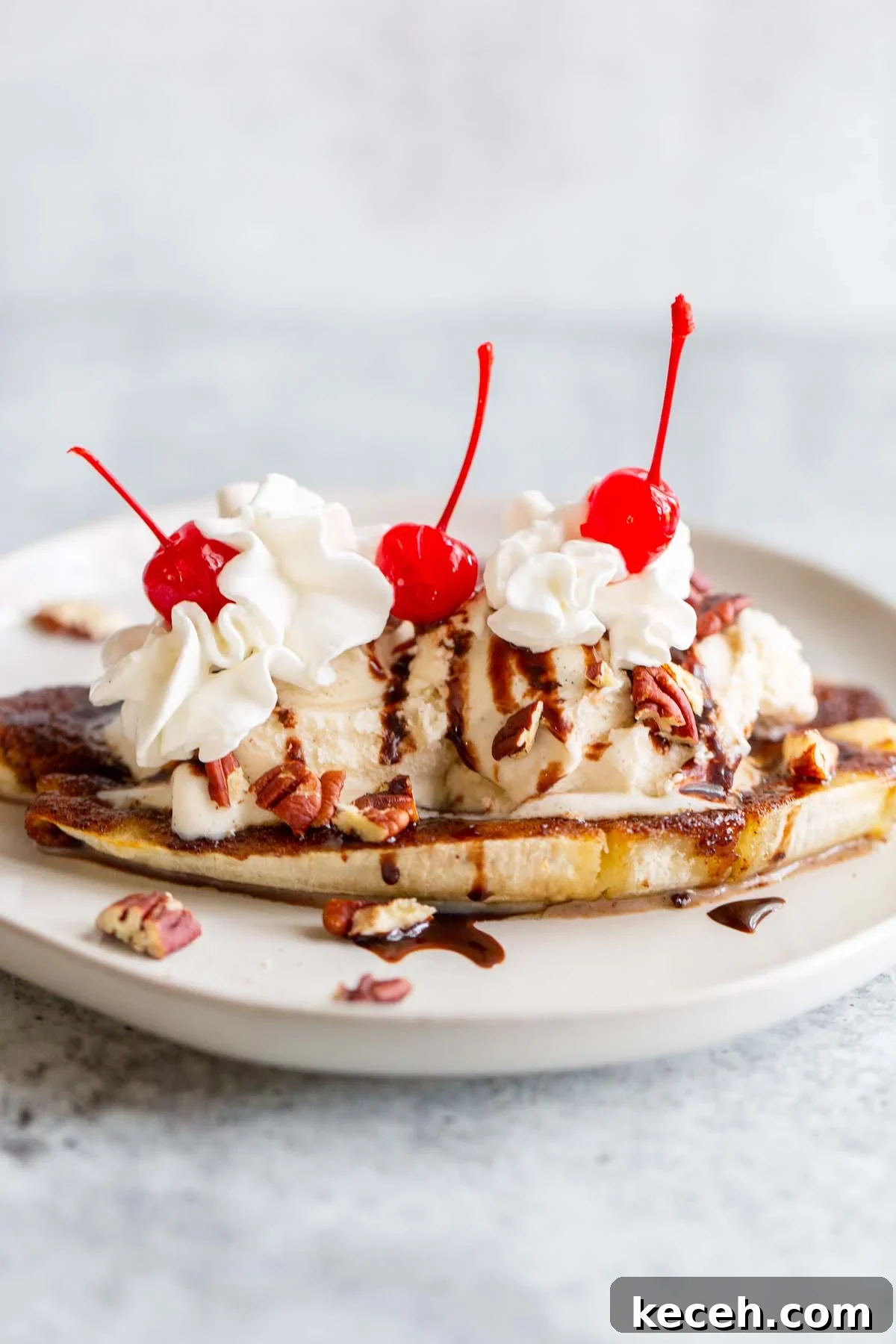 Air Fryer Banana Split Dessert with Warm Caramel and Crisp Toppings 7 Air fryer banana split with whipped cream and cherries.