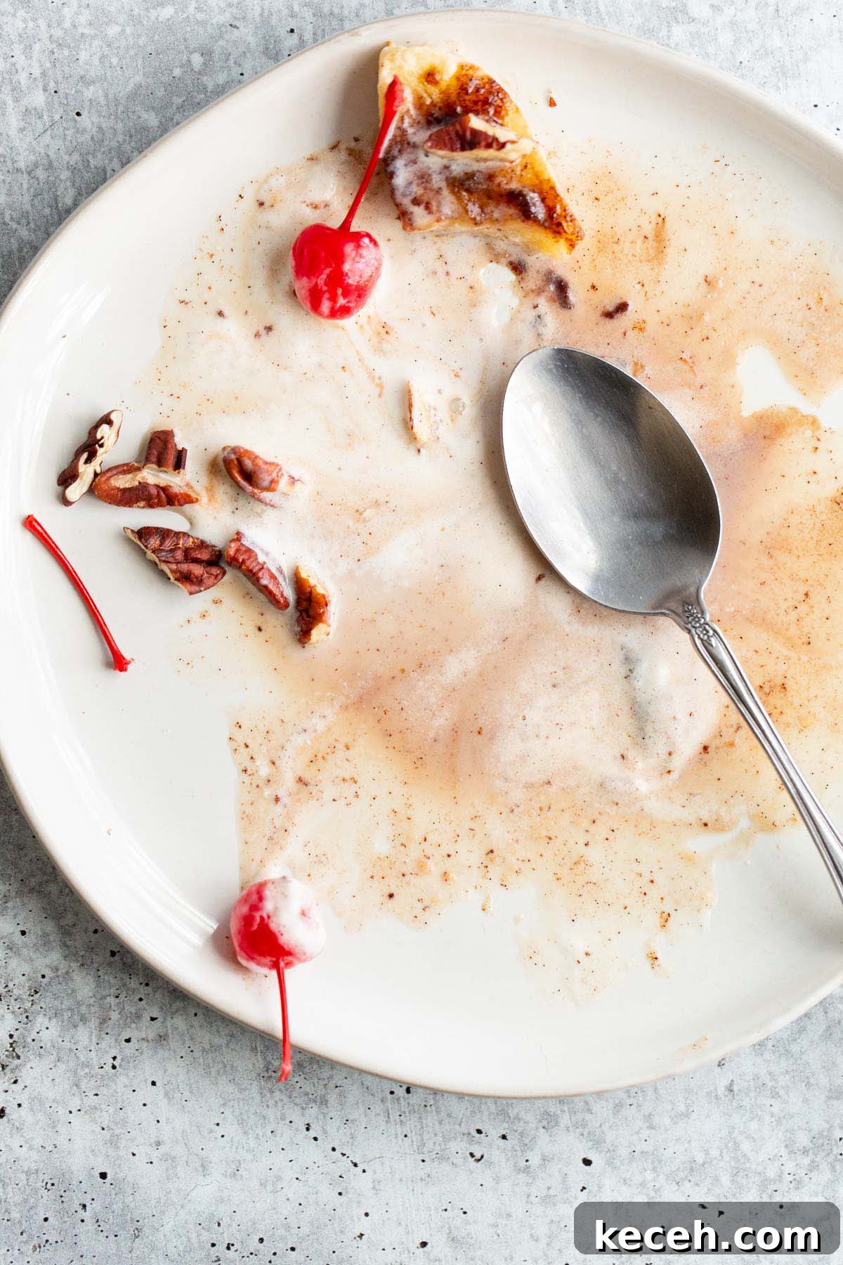 Air Fryer Banana Split Dessert with Warm Caramel and Crisp Toppings 10 Mostly eaten banana split on a plate.