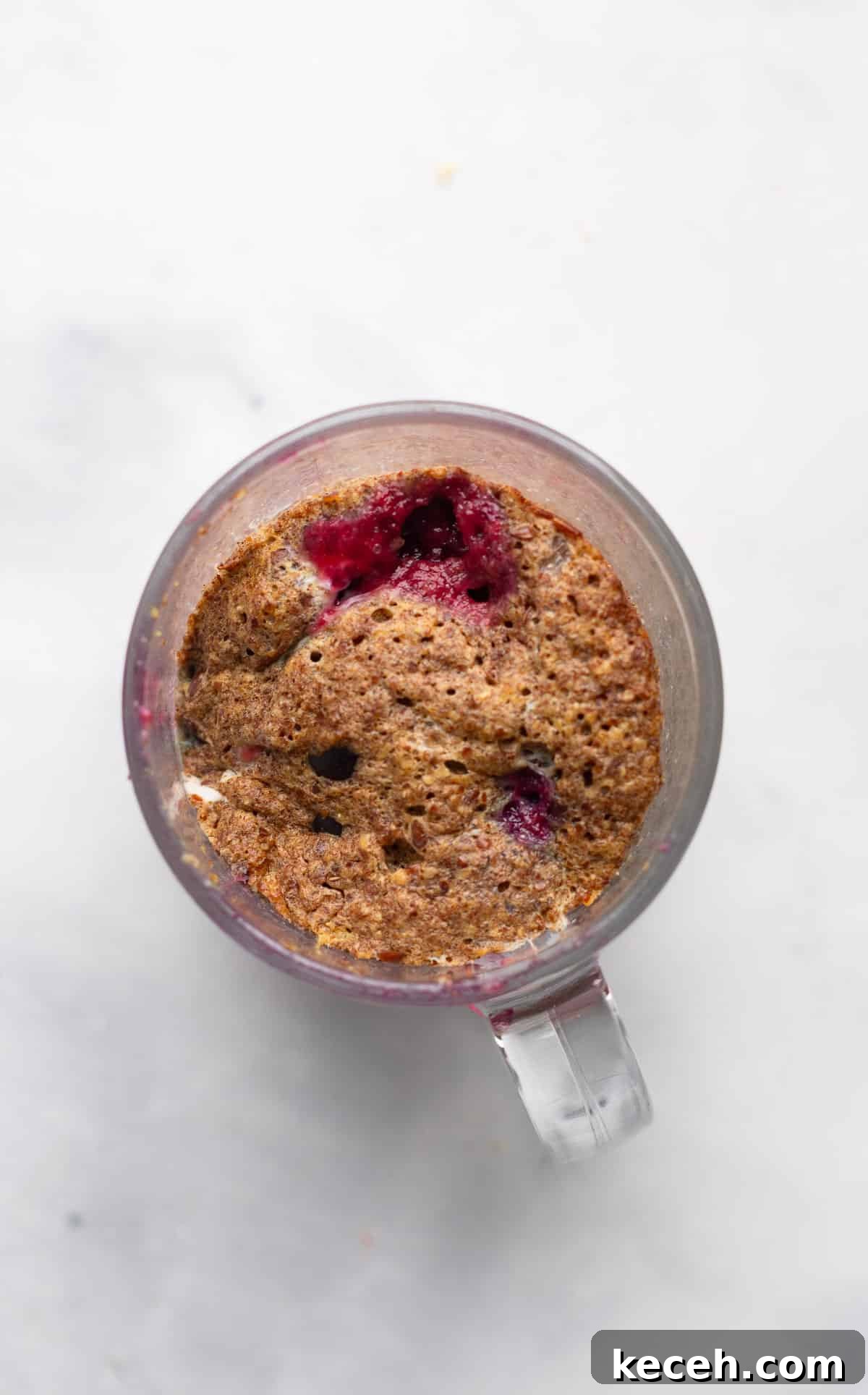 1-Minute Blueberry Mug Muffin Recipe 3 muffin in a mug mixture in glass mug
