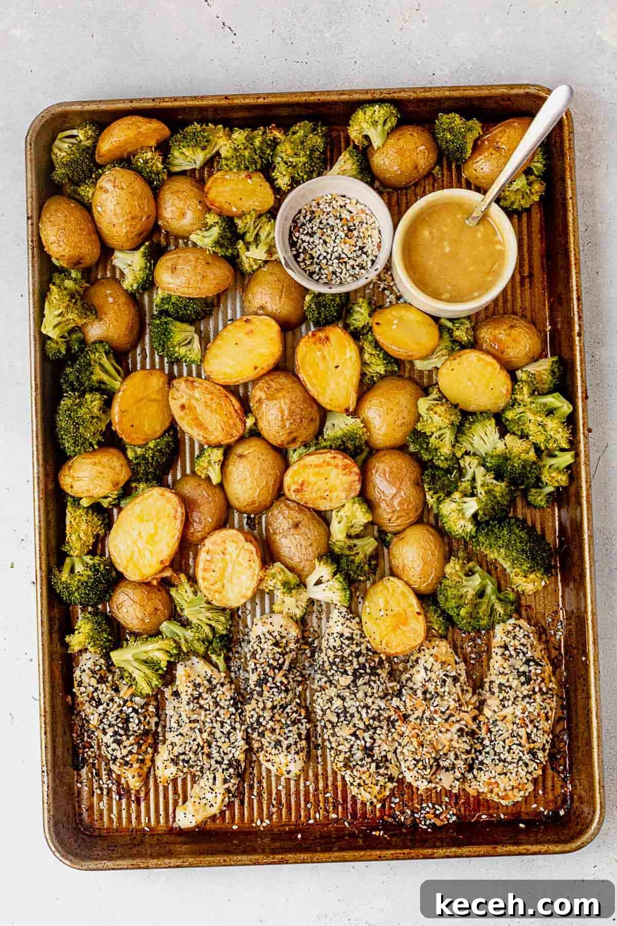 21 Flavorful Sheet Pan Dinners for Quick Weeknight Meals 4 everything bagel chicken tenders on a baking pan with veggies