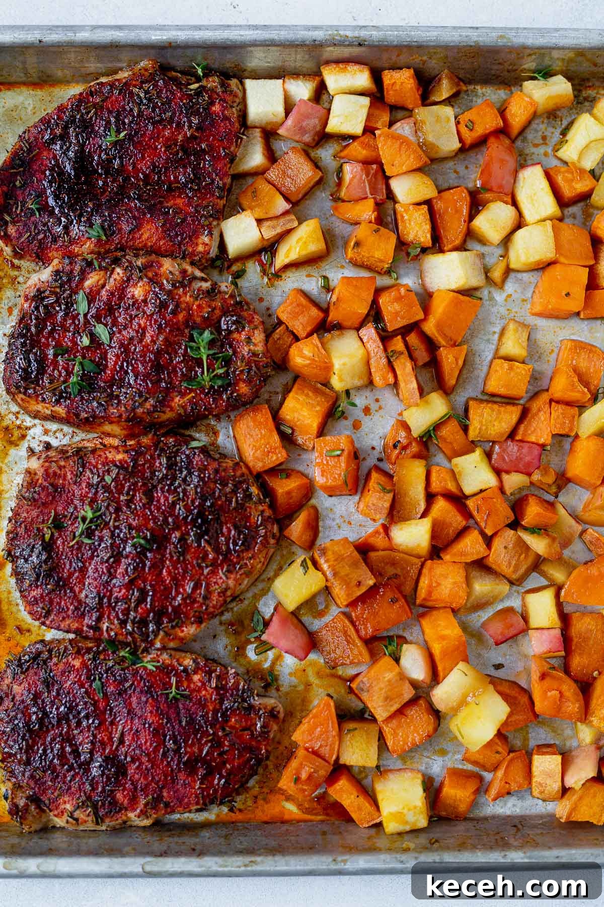 21 Flavorful Sheet Pan Dinners for Quick Weeknight Meals 5 seasoned pork chops on a sheet pan with roasted sweet potatoes and apples