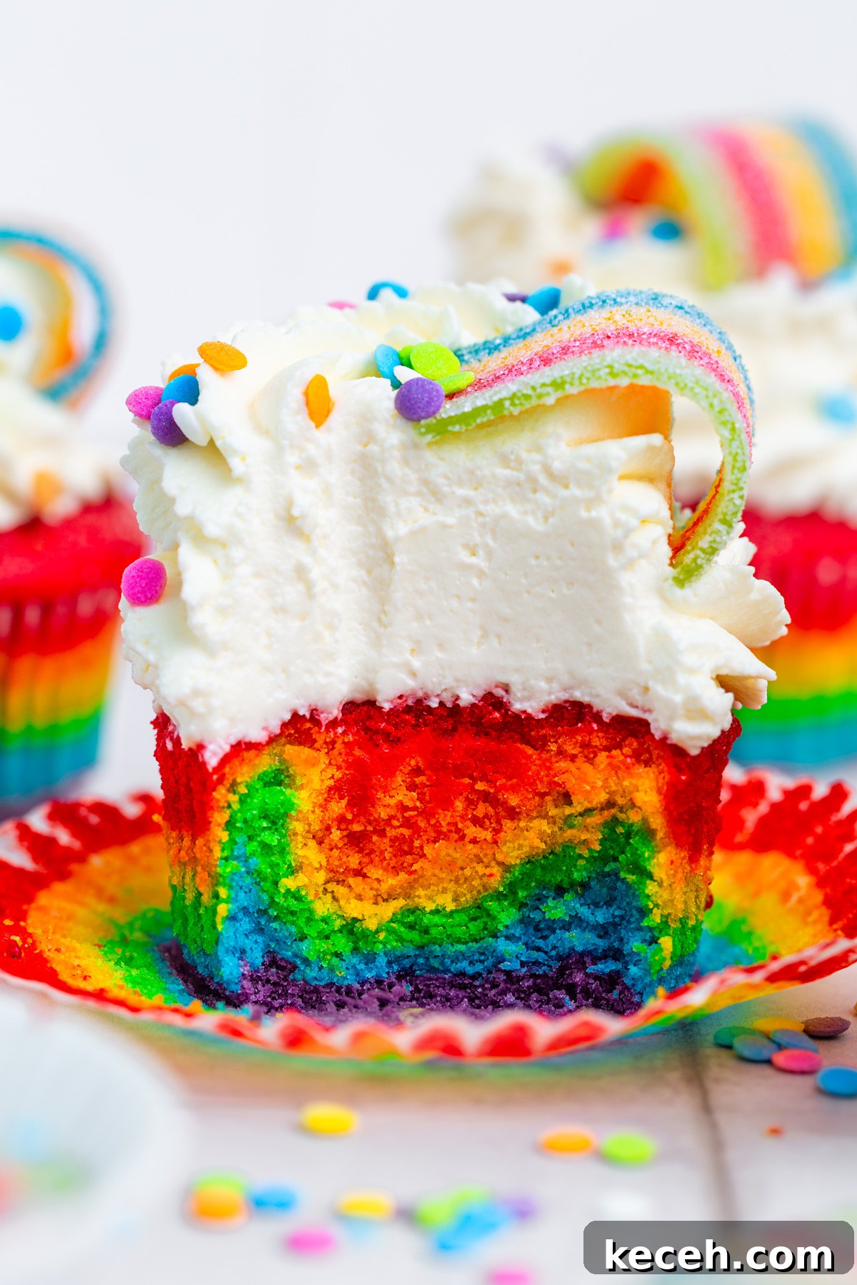 How to Make Colorful Rainbow Cupcakes at Home 11 rainbow cupcakes cut open showing bright colorful layers