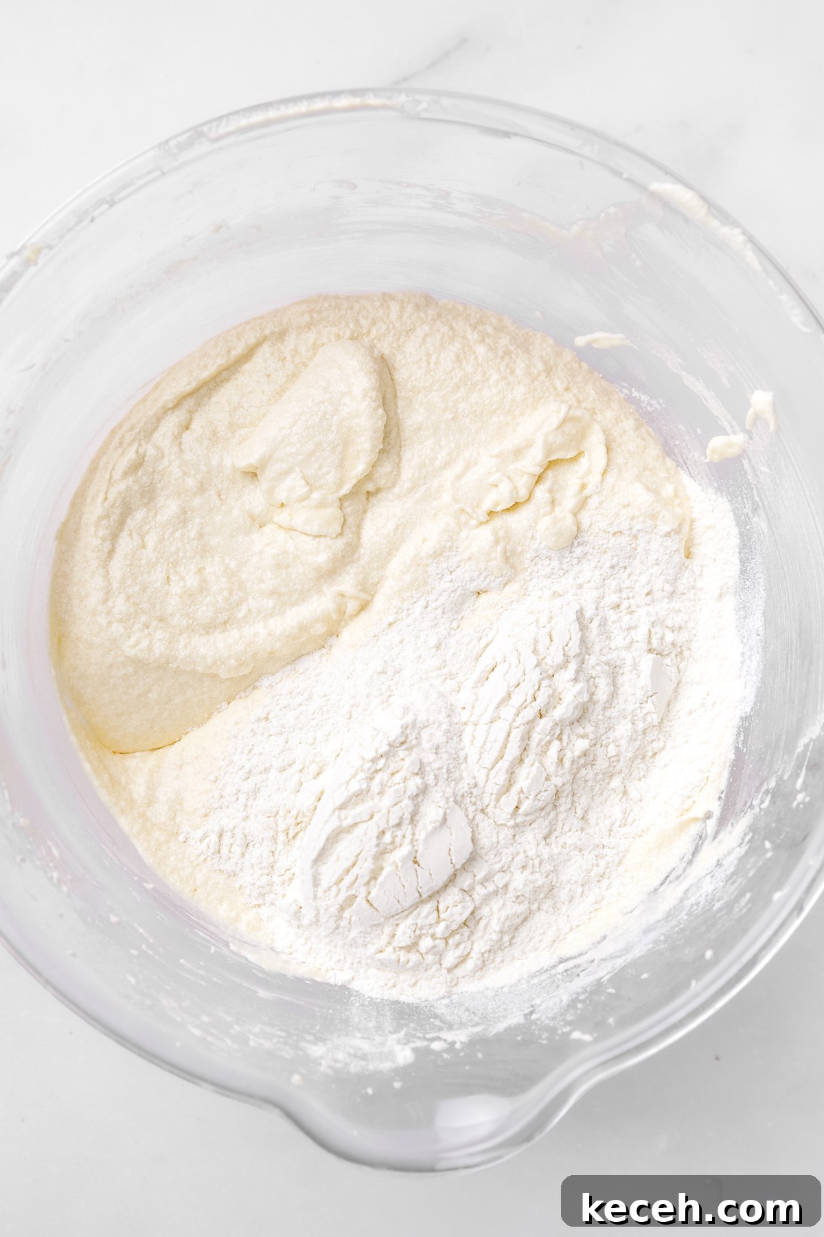 How to Make Colorful Rainbow Cupcakes at Home 6 rainbow cupcake batter with flour mixture in a mixing bowl
