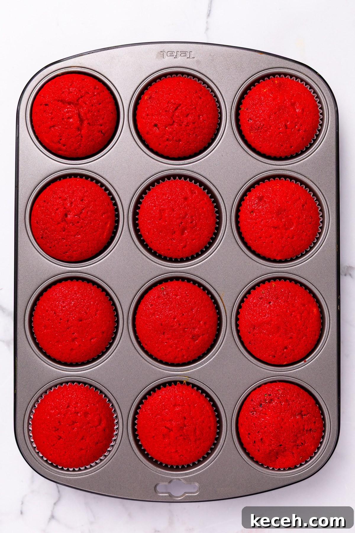 How to Make Colorful Rainbow Cupcakes at Home 9 rainbow cupcakes baked in a muffin tin with visible colorful layers