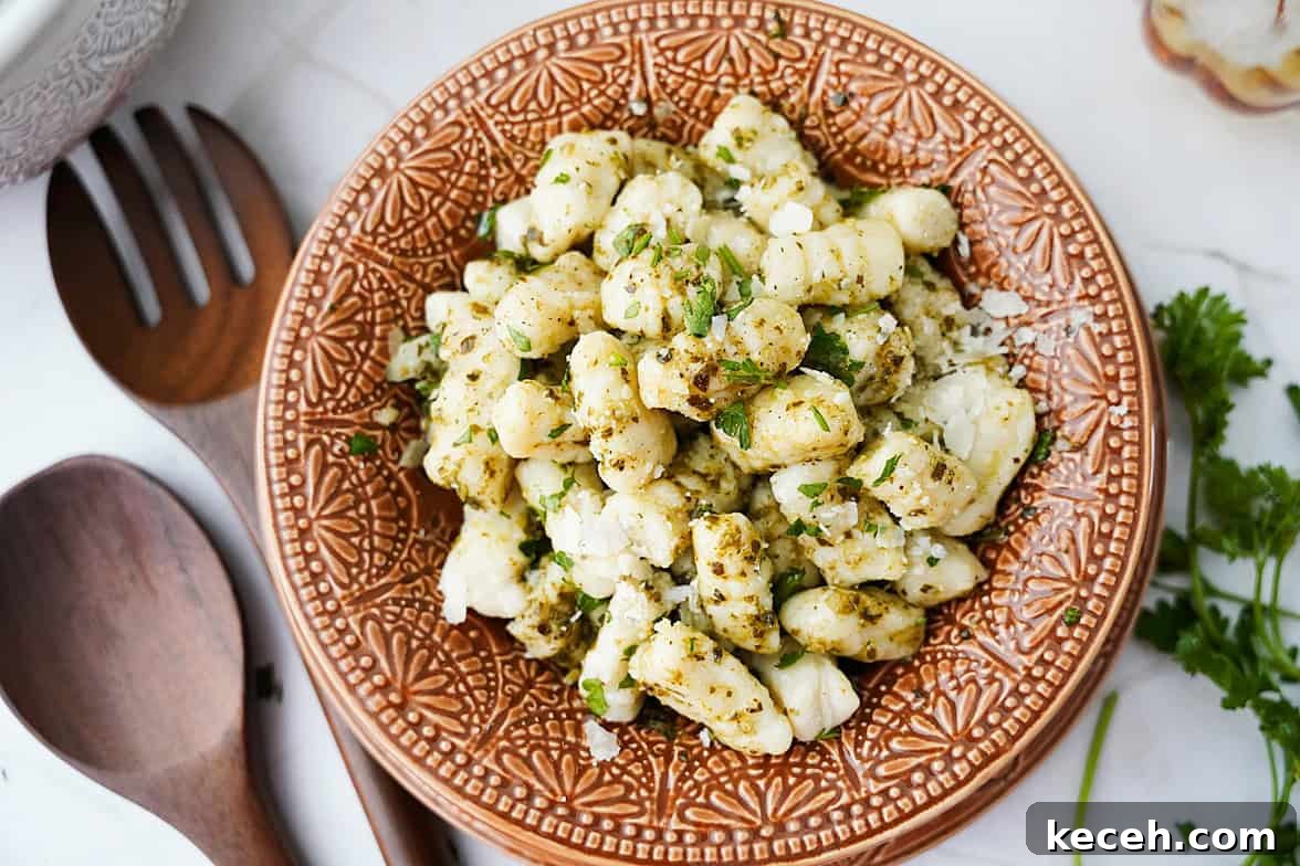 Pillowy Homemade Potato Gnocchi: Classic Italian Comfort Food 2 overhead shot of homemade potato gnochhi being served in bowl with olive oil based sauce