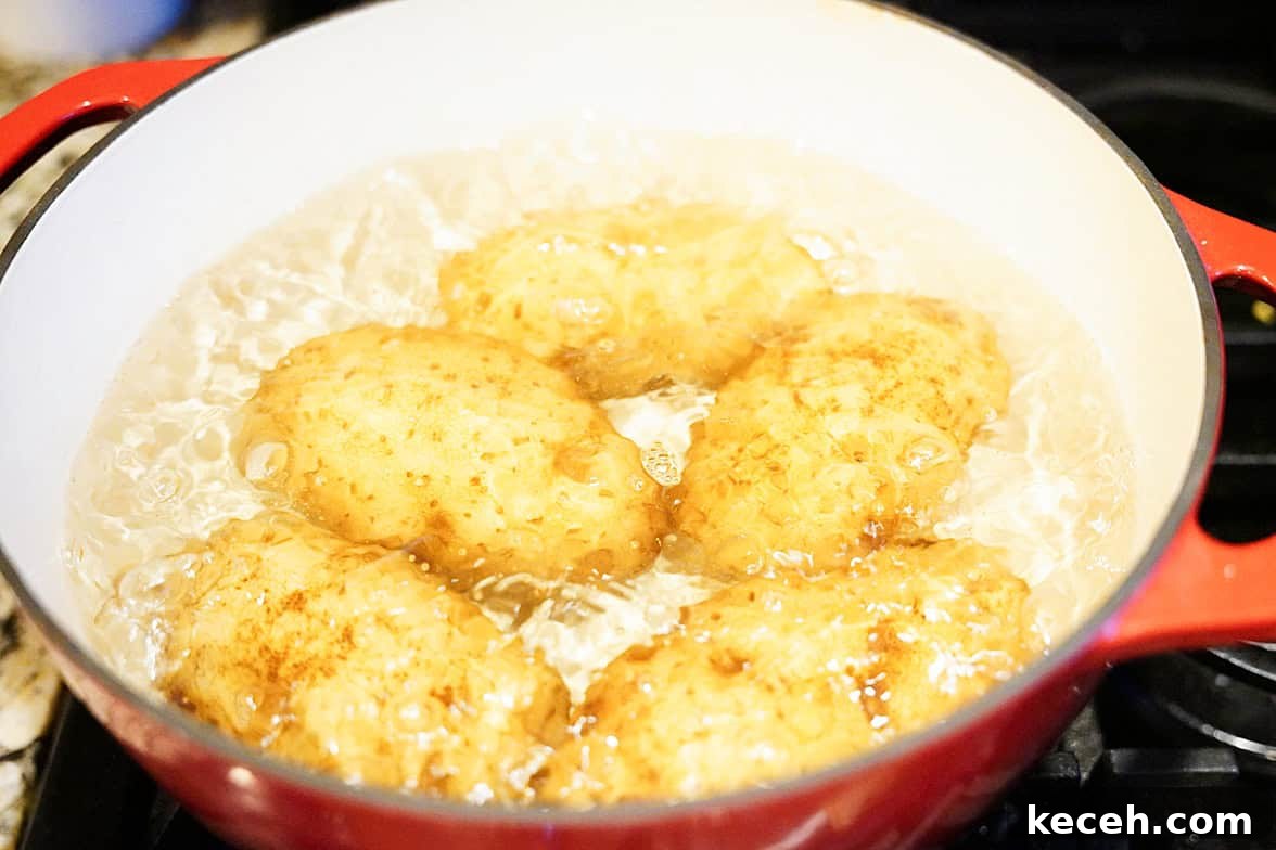 Pillowy Homemade Potato Gnocchi: Classic Italian Comfort Food 5 idaho potatoes boiling on stove in red dutch oven