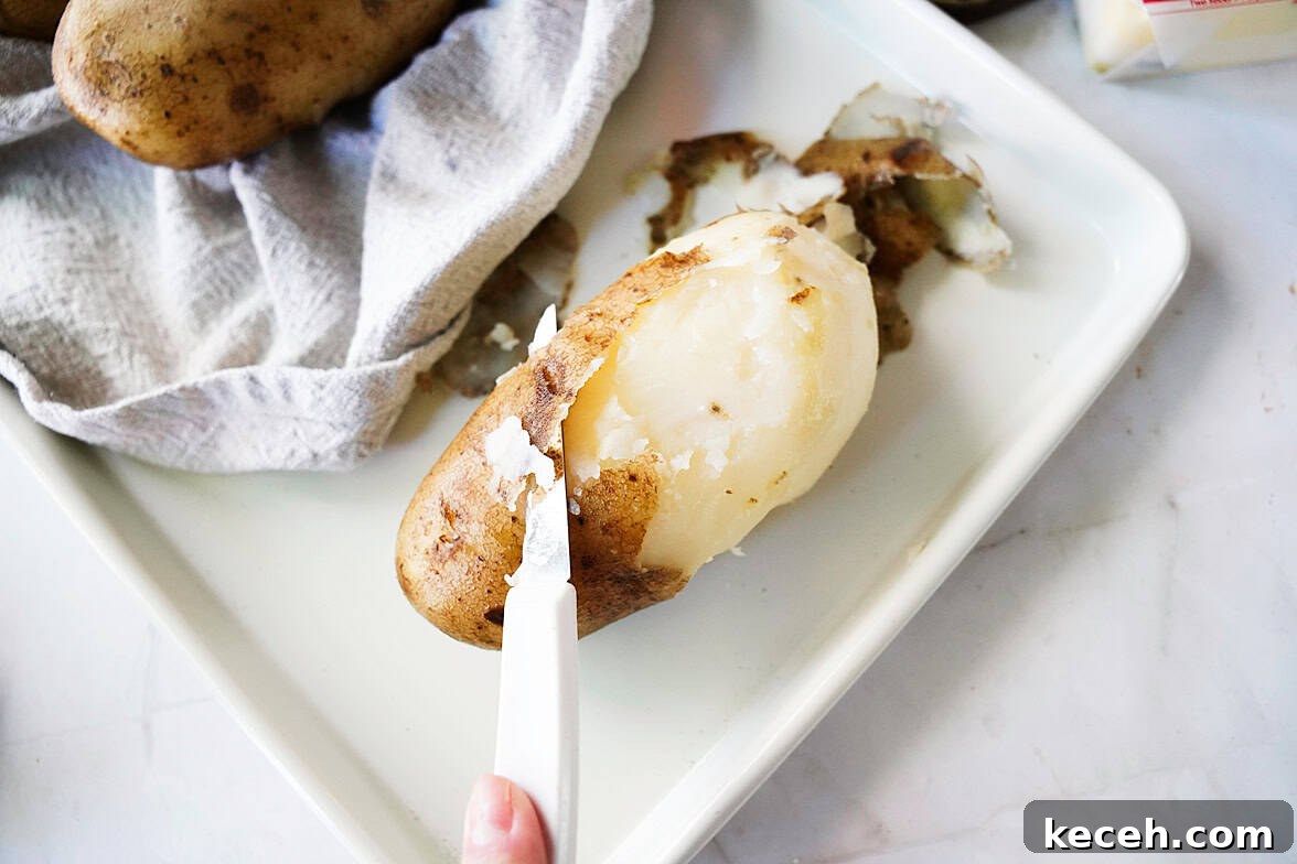 Pillowy Homemade Potato Gnocchi: Classic Italian Comfort Food 6 knife slicing potato skin off after being boiled