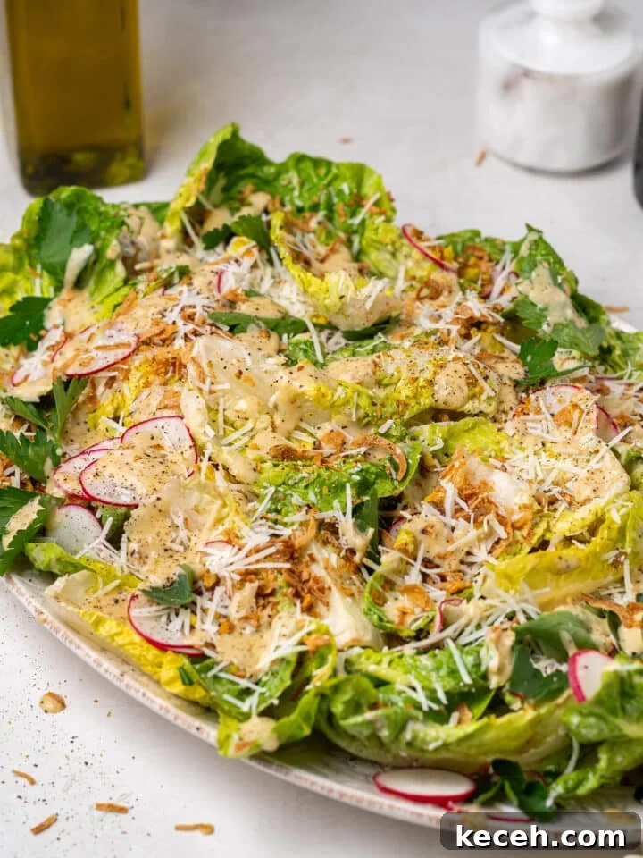 plated little gem salad with radishes, parmesan, crispy shallots, and light Caesar vinaigrette