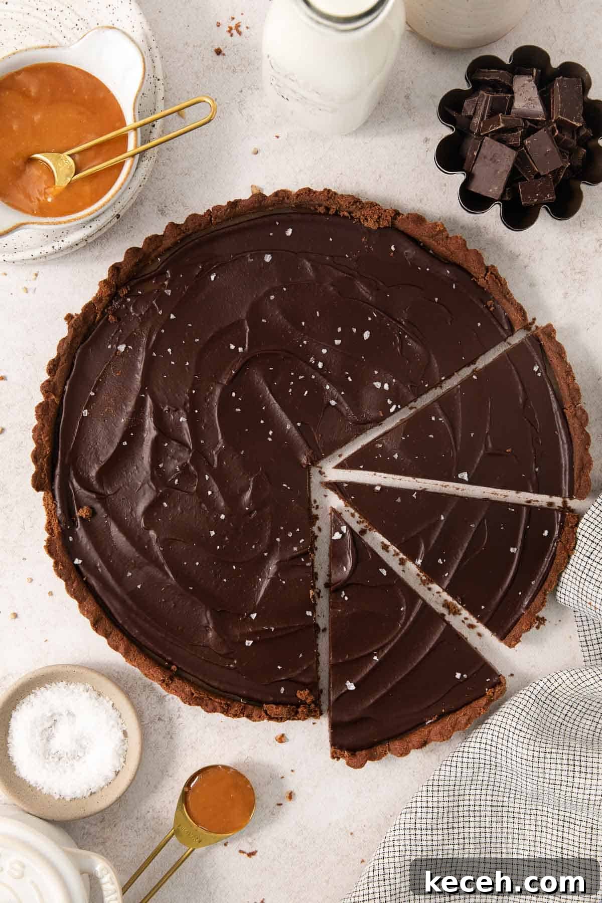 Decadent Gluten-Free Chocolate Caramel Tart Recipe 2 gluten-free chocolate caramel tart sliced on a countertop