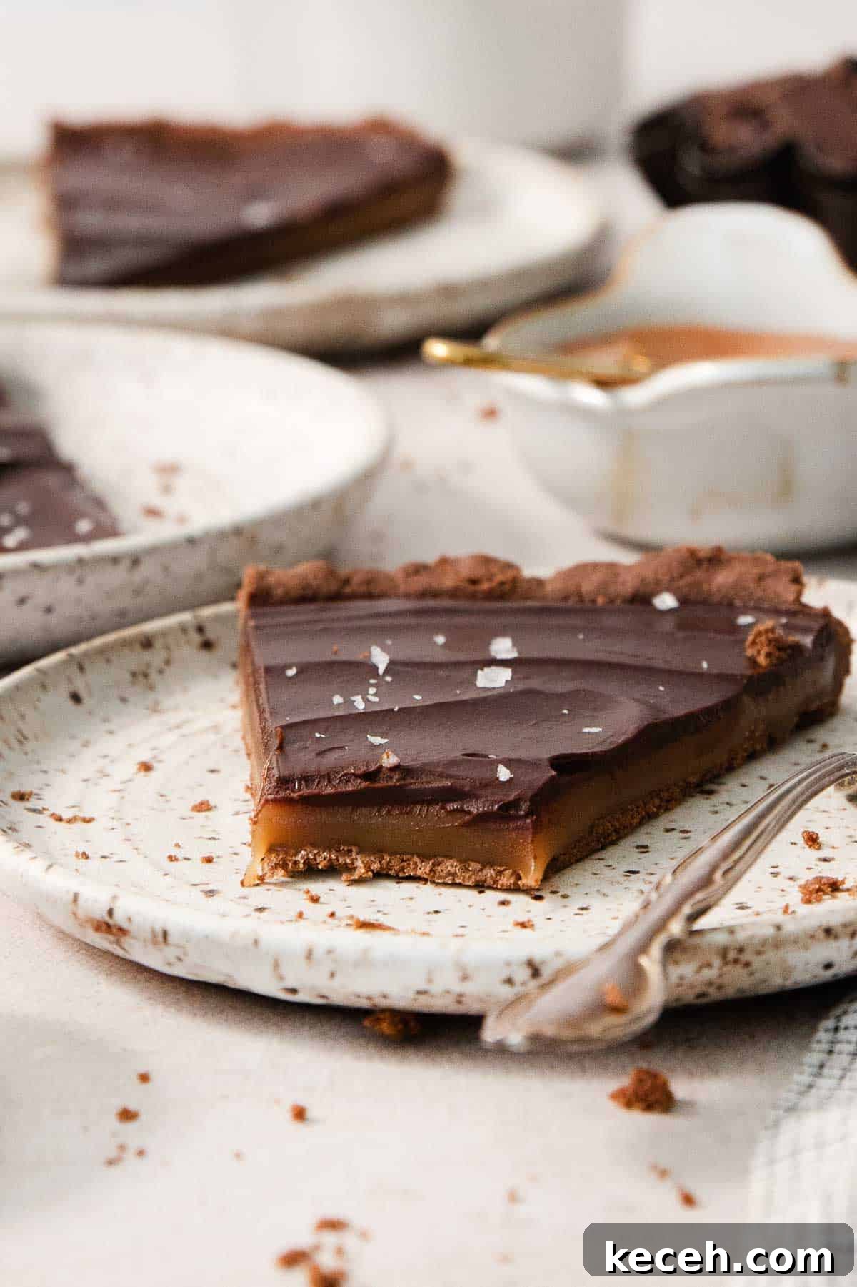 Decadent Gluten-Free Chocolate Caramel Tart Recipe 7 a slice of gluten-free chocolate caramel tart on a plate