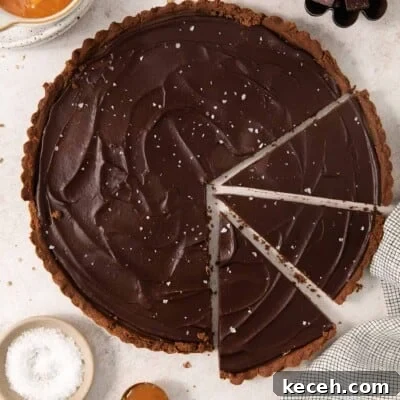 Decadent Gluten-Free Chocolate Caramel Tart Recipe 8 gluten-free chocolate caramel tart sliced on a countertop
