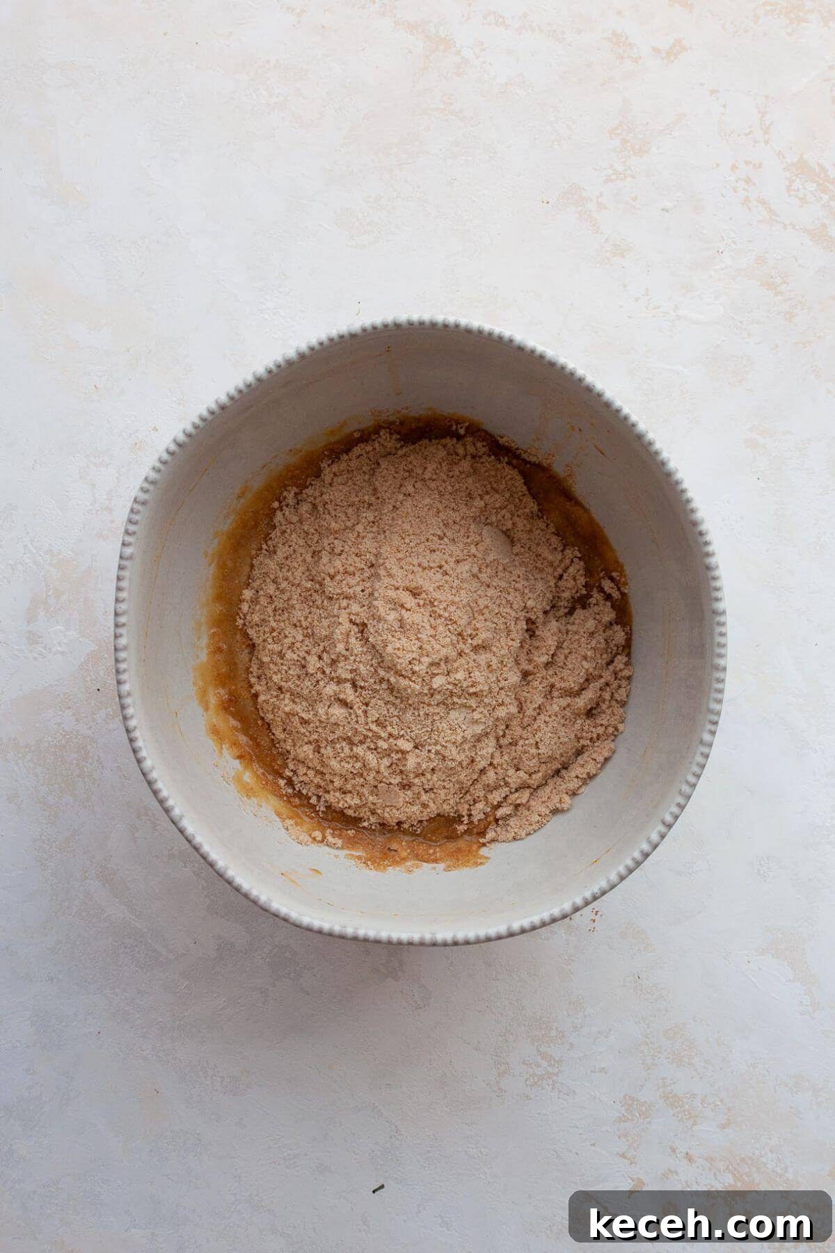 Moist Whole Wheat Coffee Cake with Yogurt and Honey 4 Wet ingredients for almond flour coffee cake mixed together in a bowl.